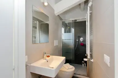 a bathroom with a sink and a toilet and a shower at Torre Argentina in Rome