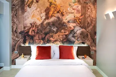a bedroom with a painting on the wall above a bed at Dreamers in Belsiana Condotti Int 9 in Rome