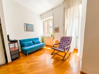 a living room with a blue couch and a chair at Central Boutique Apartment for2 in Rome