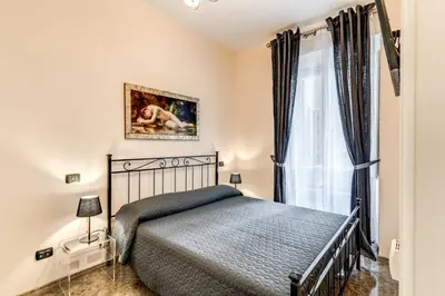 a bedroom with a bed and a window at Apartment near Via Veneto in Rome