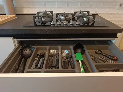 a stove top oven with utensils in a drawer at Your window on San Pietro in Rome