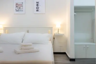 a white bed with two white pillows on it at Elegant suite in Prati, 5 minutes from the Vatican in Rome