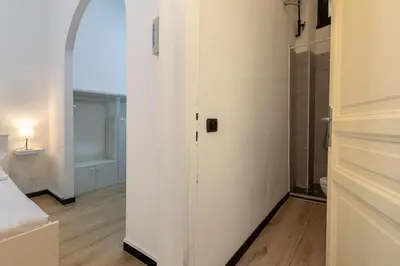 a room with a white door and a bathroom at Elegant suite in Prati, 5 minutes from the Vatican in Rome