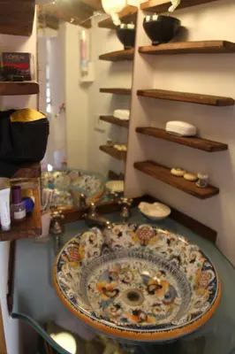 a counter with a sink in a room with shelves at Campo dei Fiori Jewel in Rome