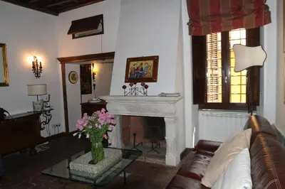 a living room with a couch and a fireplace at Campo dei Fiori Jewel in Rome