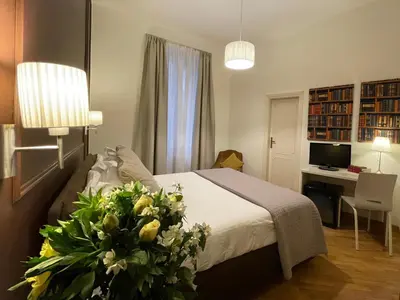 a bedroom with a bed and a desk with a computer at Banchi Vecchi Stay Rooms in Rome