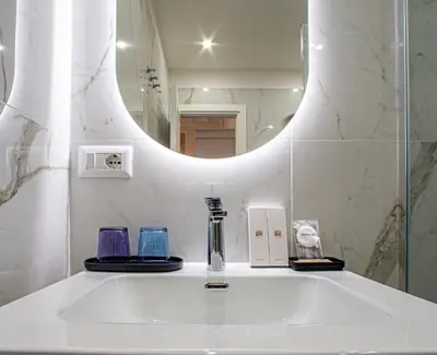a bathroom with a sink and a mirror at L'Angolo Sereno Guesthouse Rome Termini in Rome