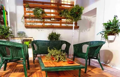 a patio with four chairs and a table with plants at ColosseoHome in Rome