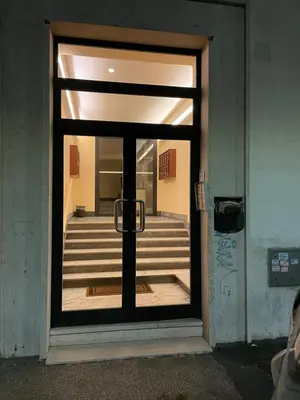a glass door with a view of a staircase at DOMUS I Cozy Apt -20 min from Colosseum in Rome