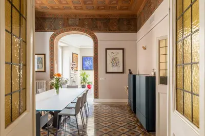 a dining room with an archway and a table and chairs at iFlat Timeless Elegance in the Center of Rome in Rome