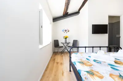 a bedroom with two beds and a table with chairs at Termini Roma Imperiale in Rome