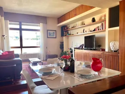 a living room with a table with wine glasses on it at Roma San Pietro - Elegante appartamento con vista in Rome