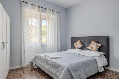 a white bedroom with a bed and a window at Star Guest House Rome in Rome