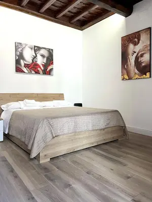 a bedroom with a bed and two pictures on the wall at Spagna Home in Rome