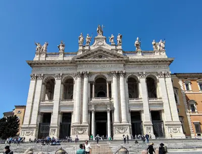 a large building with people walking in front of it at Re di Room in Rome