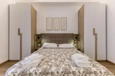 a bedroom with a large bed with two doors at Urbano 29 apartment in Rome