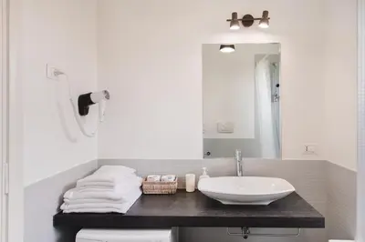 a bathroom with a sink and a mirror at Maison 46 in Rome