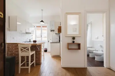 a kitchen with white cabinets and a counter top at Maison 46 in Rome