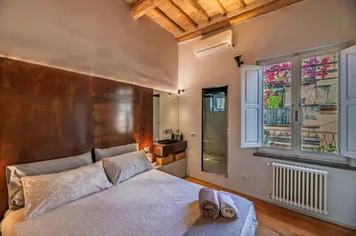 a bedroom with a large bed and a window at Giulia's House, Monti in Rome