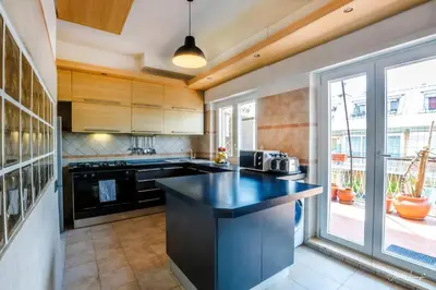a kitchen with a black counter top and a window at Magikrooms Domus in Rome