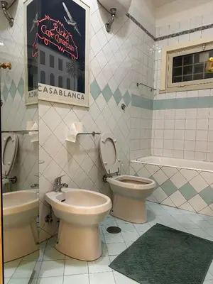 a bathroom with a toilet and a bidet and a sink at Scarpellini home Parioli in Rome