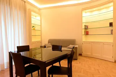 a dining room with a glass table and chairs at Scarpellini home Parioli in Rome
