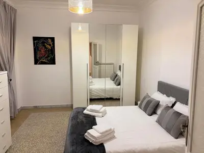 a bedroom with a large bed and a mirror at Luxury Apartment in Prati in Rome