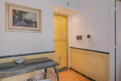 a room with a table and a painting on the wall at Roman Forum apartament in Rome