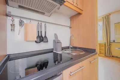 a kitchen with a sink and a counter with utensils at Roman Forum apartament in Rome
