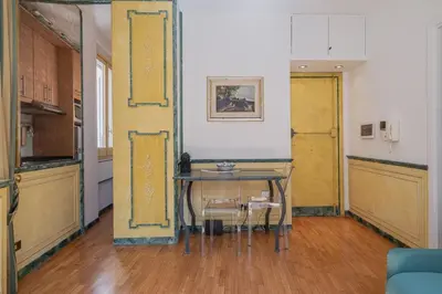 a kitchen with a table and chairs in a room at Roman Forum apartament in Rome