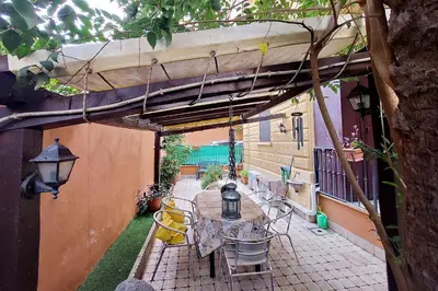 a patio with a table and chairs under a pergola at Viale Trastevere by Halldis in Rome