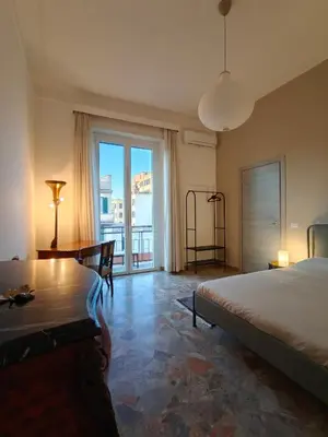 a bedroom with a bed and a desk and a window at CasAdelia in Rome