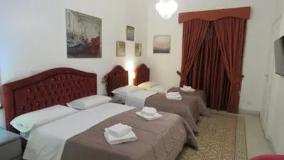 a hotel room with two beds and a window at Sweet Home Inn in Rome