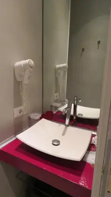a bathroom with a white sink and a mirror at Sweet Home Inn in Rome
