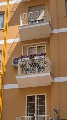 a building with a balcony with flowers on it at A Casa di Nico - Metro B1 Conca d 'Oro in Rome