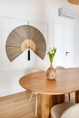 a dining room table with a vase of flowers on it at Davìta - Casa Leda in Rome