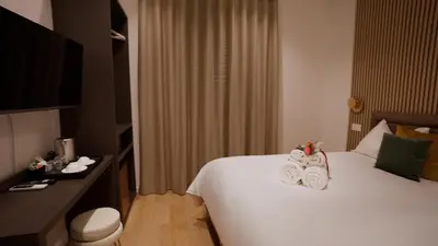 a hotel room with a bed with towels on it at Domus Augusti in Rome