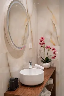a bathroom with a white sink and a mirror at Domus Augusti in Rome