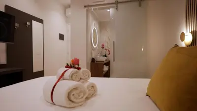 a pile of towels sitting on top of a bed at Domus Augusti in Rome