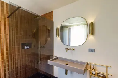 a bathroom with a sink and a shower with a mirror at Daplace - Palazzo Serpe Suites near Colosseum in Rome