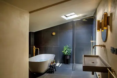 a bathroom with a tub and a sink at Daplace - Palazzo Serpe Suites near Colosseum in Rome