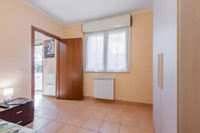 a living room with a door and a window at Casa Roma - La Casetta di Vale in Rome