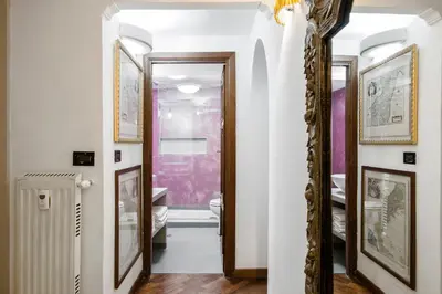 a hallway with a toilet and a mirror at Charming Pantheon Apt in the heart of Rome in Rome