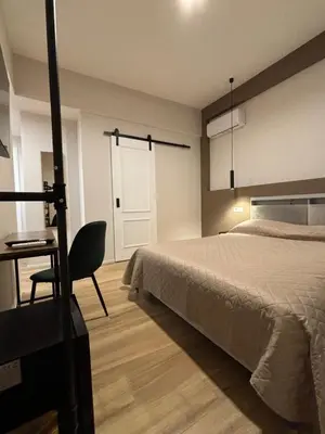 a bedroom with a bed and a desk and a chair at Eva suite in Rome