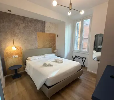 a bedroom with a bed with white towels on it at Maison Rasella Suites in Rome