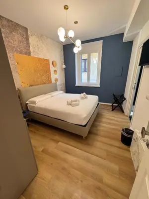 a bedroom with a bed with towels on it at Maison Rasella Suites in Rome