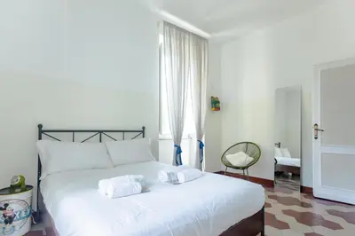 a bedroom with a white bed with towels on it at Vintage Vibes in Testaccio - Cale 07 in Rome