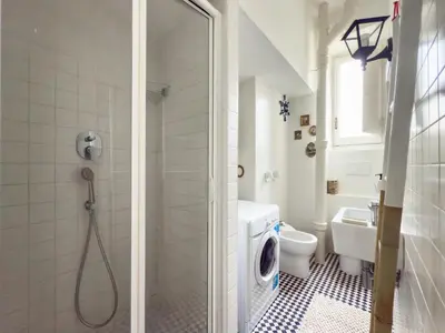 a bathroom with a shower and a toilet and a sink at Vintage Vibes in Testaccio - Cale 07 in Rome