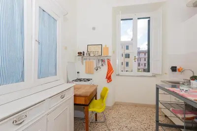 a kitchen with a table and a yellow chair at Vintage Vibes in Testaccio - Cale 07 in Rome