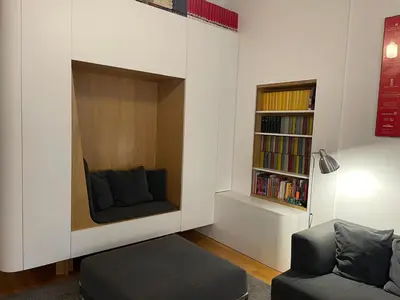 a living room with a couch and a book shelf at Bollo flat in Rome